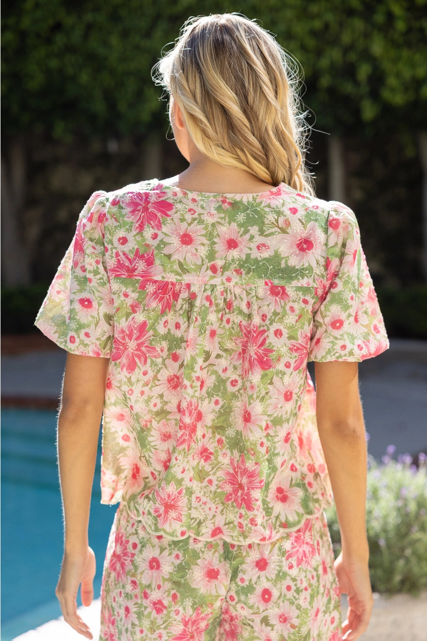Woman wearing a floral dress by a poolside