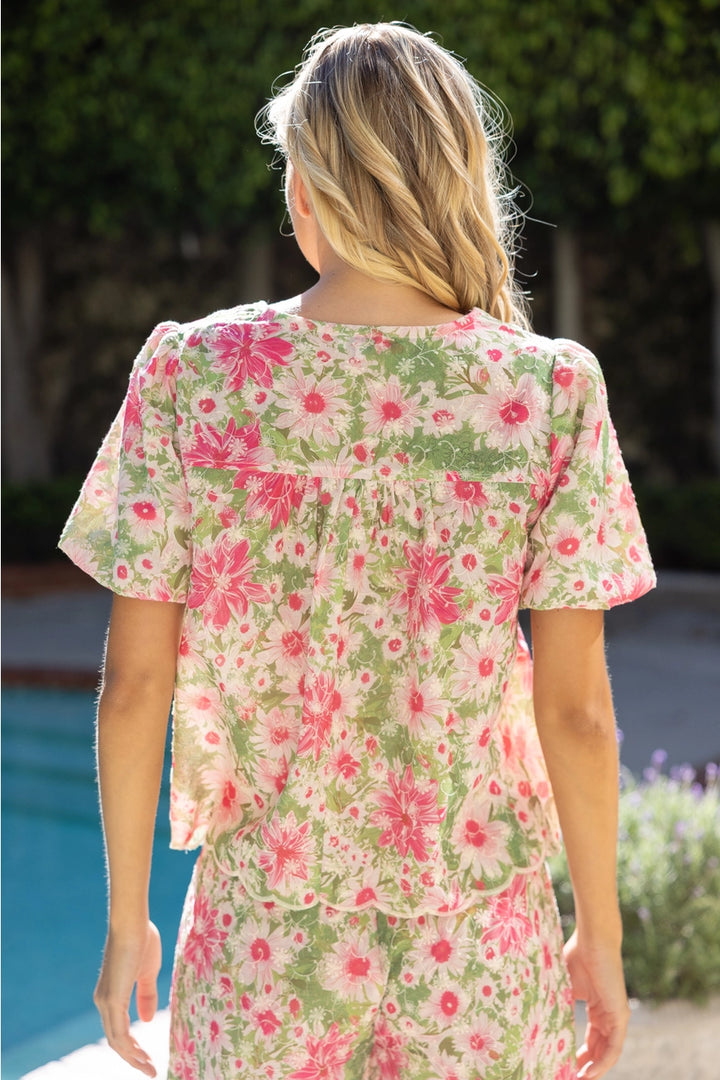 Woman wearing a floral dress by a poolside
