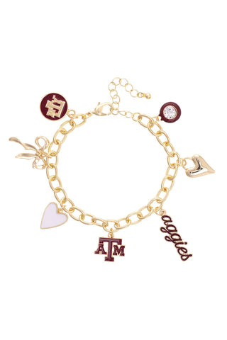 Gold bracelet with various charms including a heart, 'ATM', and 'aggies' on a white background