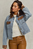 Woman wearing a denim jacket with brown patches and leather pants against a neutral background