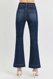 Dark blue jeans worn by a person on a white background