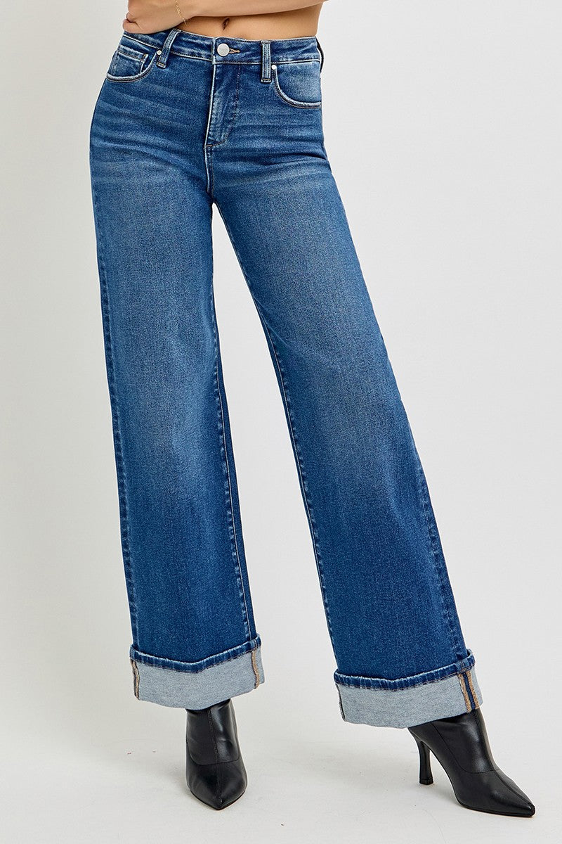Blue jeans worn by a person on a white background