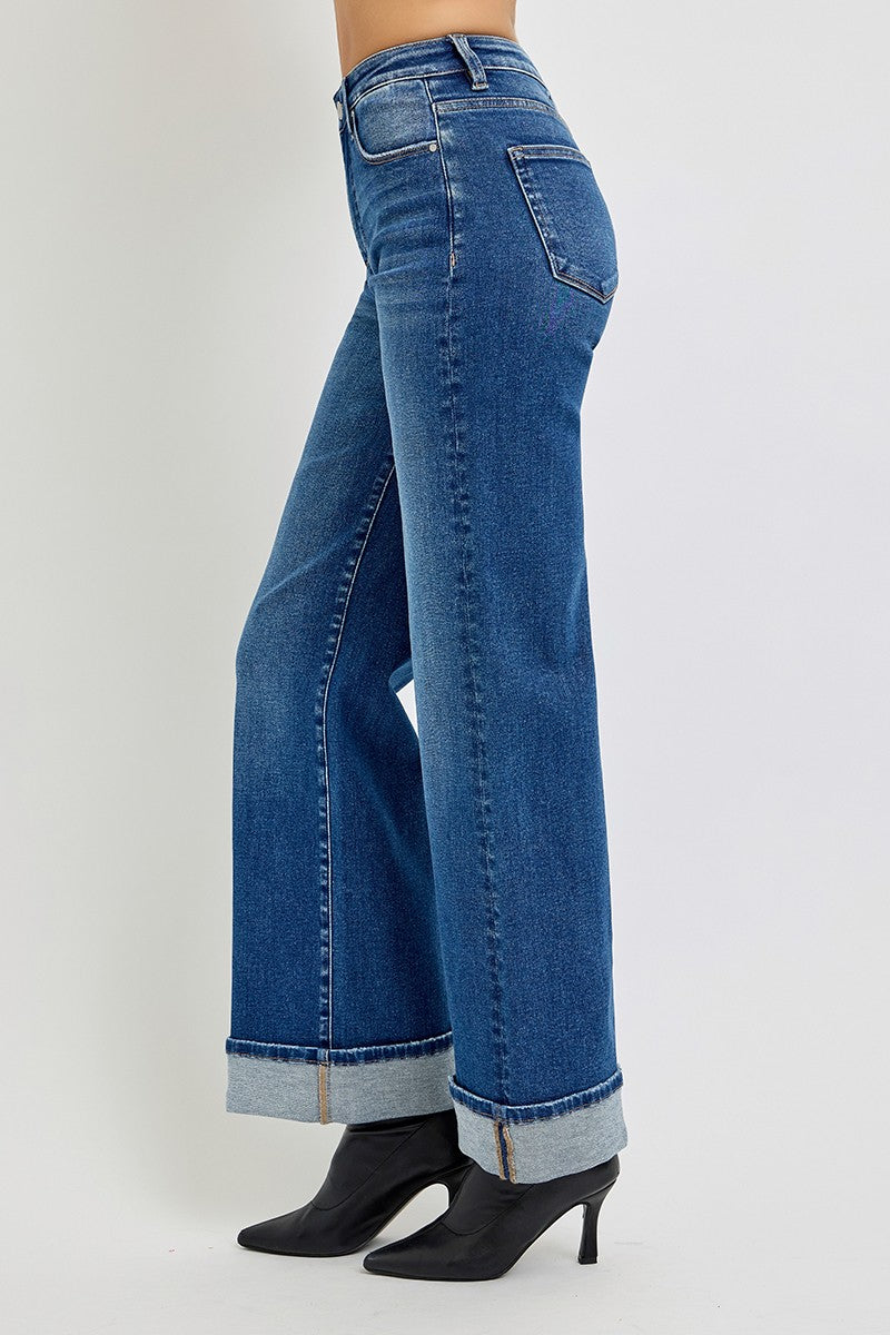 Blue jeans worn by a person on a white background