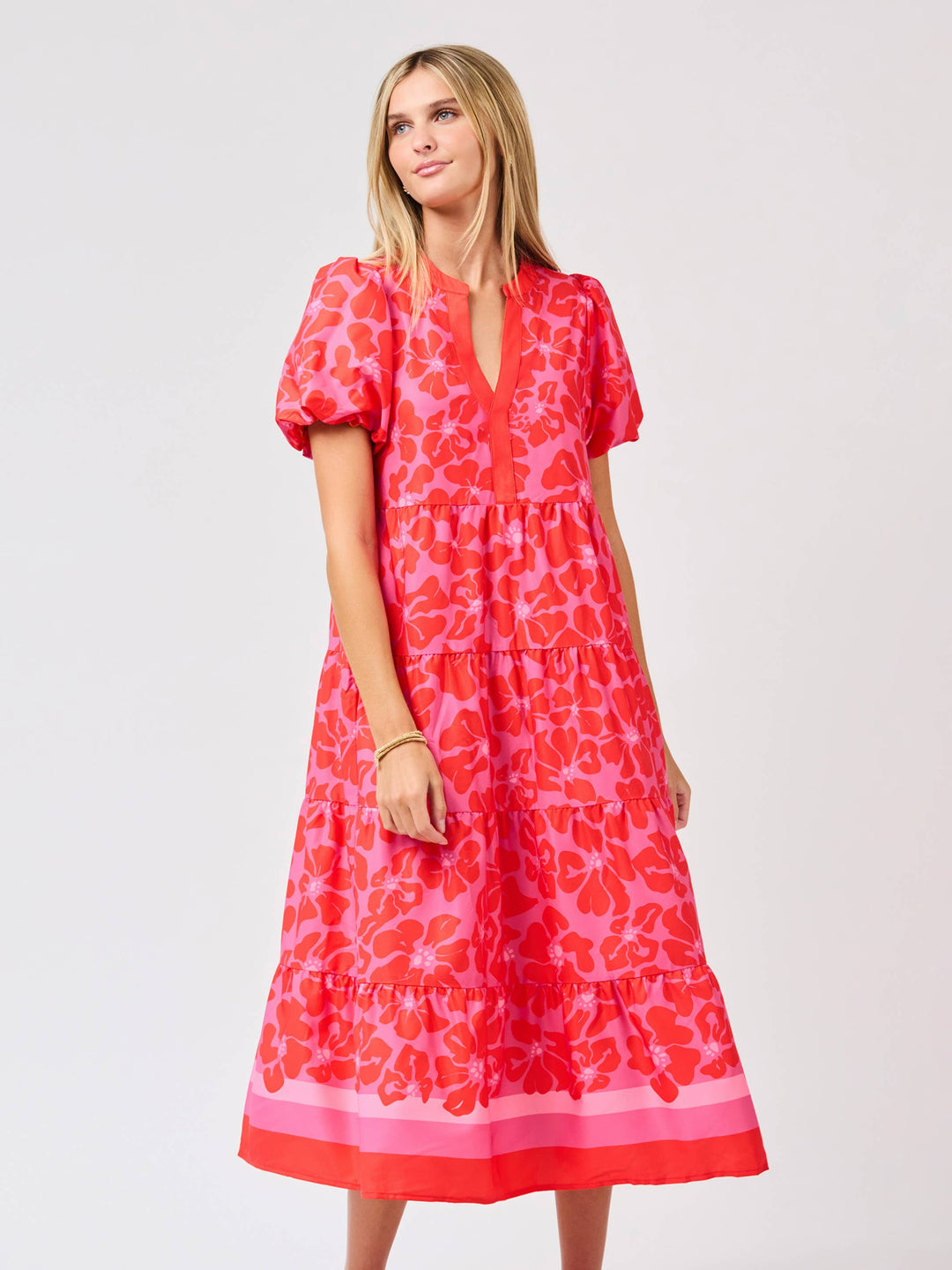 Woman wearing a red floral dress on a white background