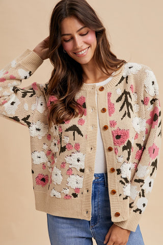 Woman wearing a floral patterned cardigan on a beige background