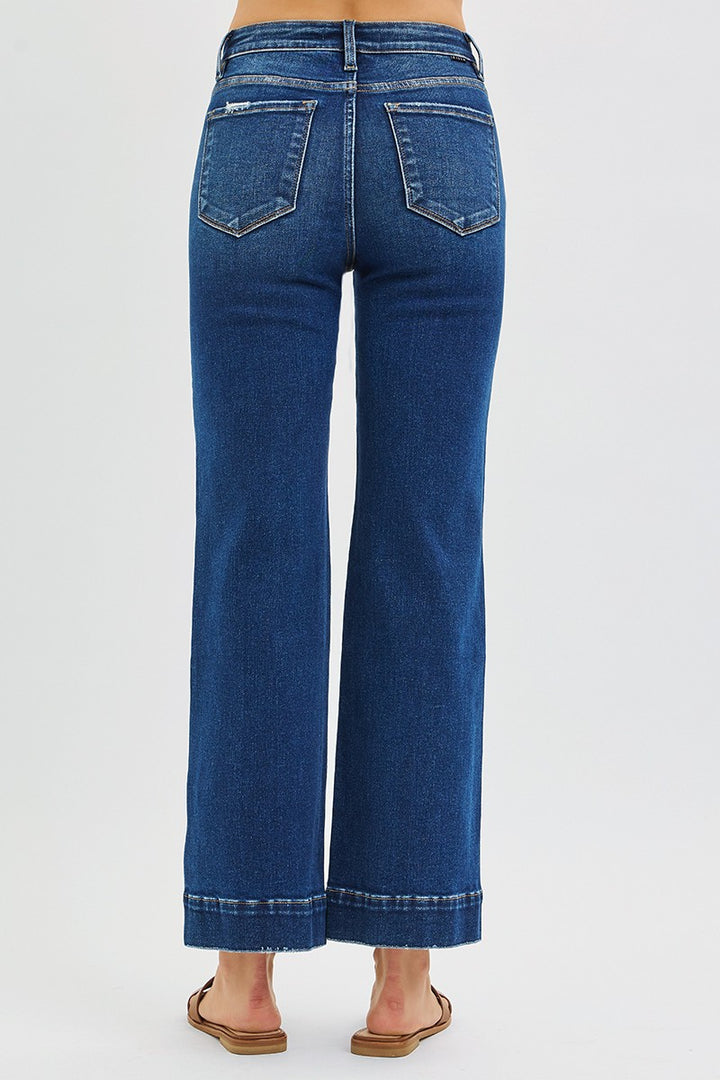 Blue jeans worn by a person on a white background