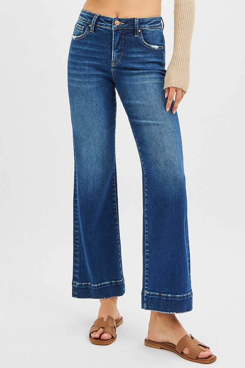 Blue jeans worn by a person on a white background