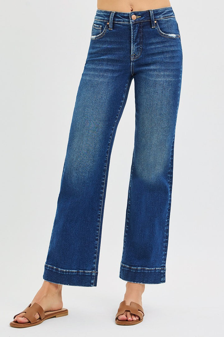 Blue jeans worn by a person on a white background
