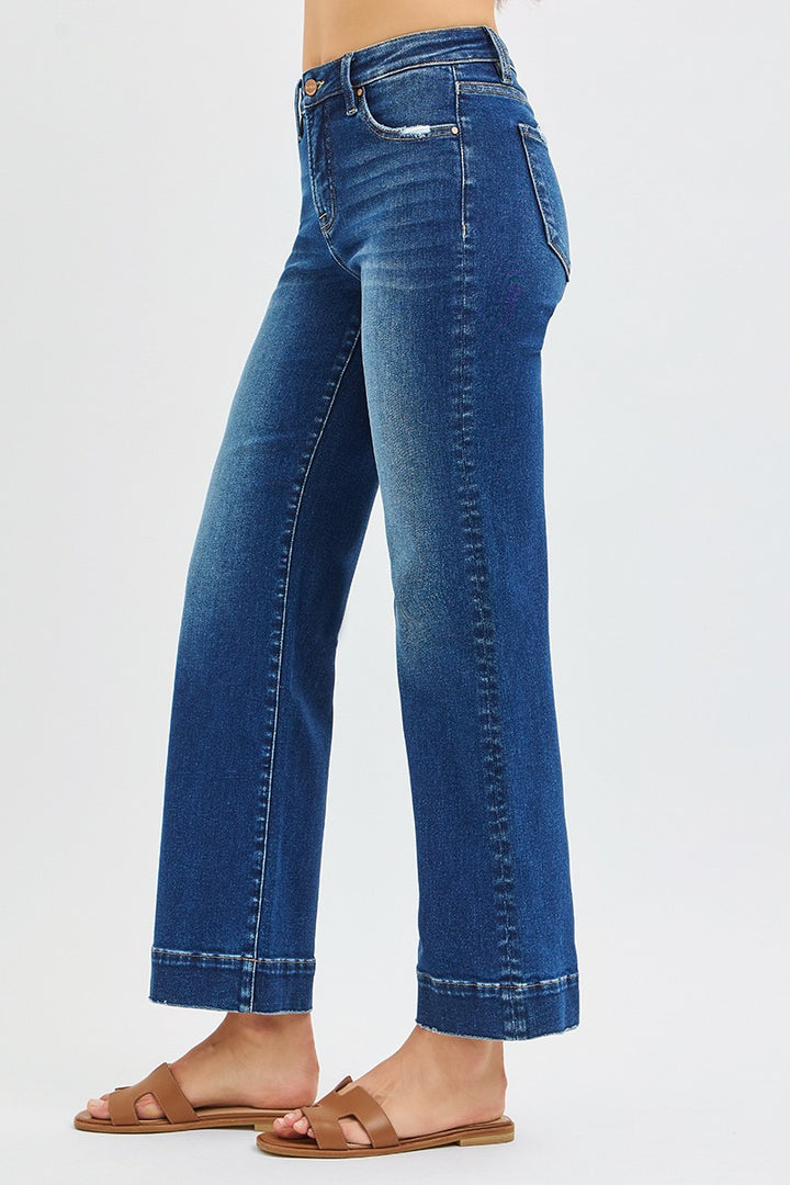 Blue jeans worn by a person on a white background