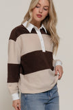 Woman wearing a striped sweater with a plain background