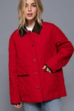 Person wearing a red jacket with brown trim on a gray background