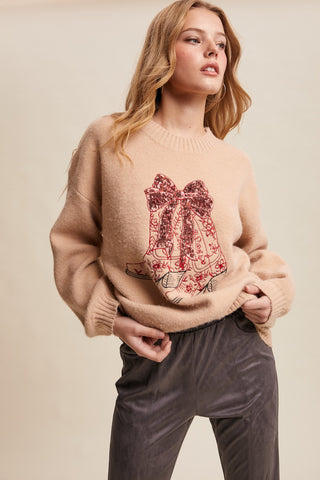 Woman wearing a beige sweater with a red floral design on a beige background