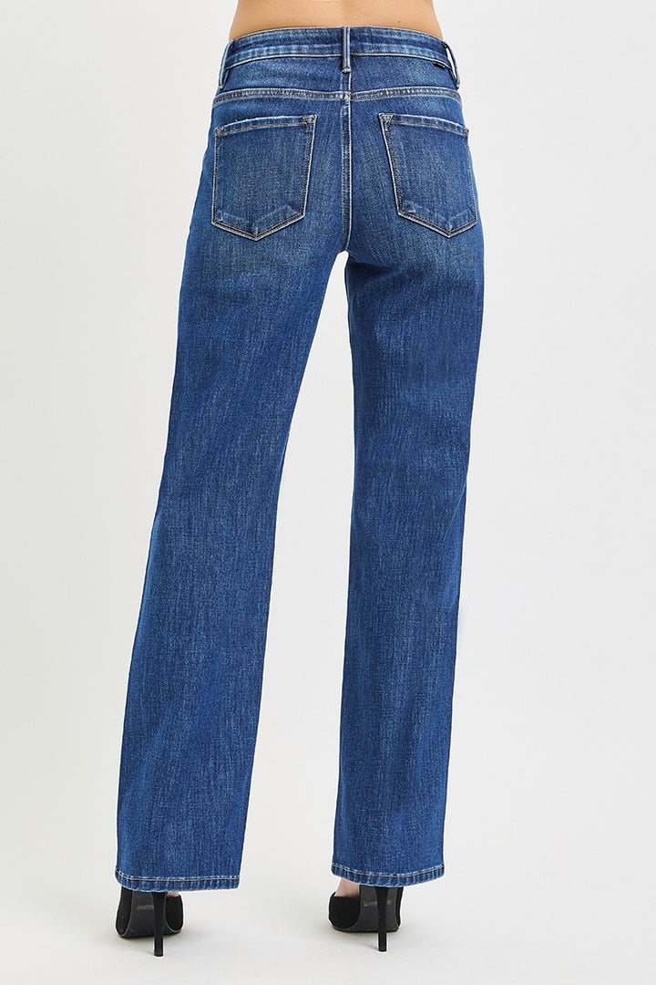 Blue jeans worn by a person on a white background