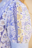 Close-up of a floral-patterned garment with blue and gold designs.