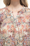 Close-up of a person wearing a patterned shirt with a geometric design.