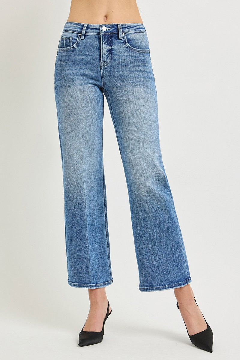 Blue jeans worn by a person on a light gray background