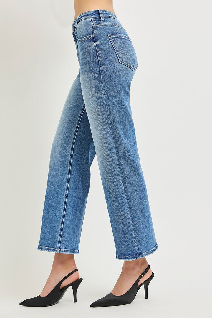 Blue jeans worn by a person on a white background