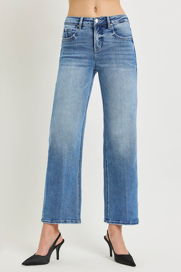 Blue jeans worn by a person on a white background