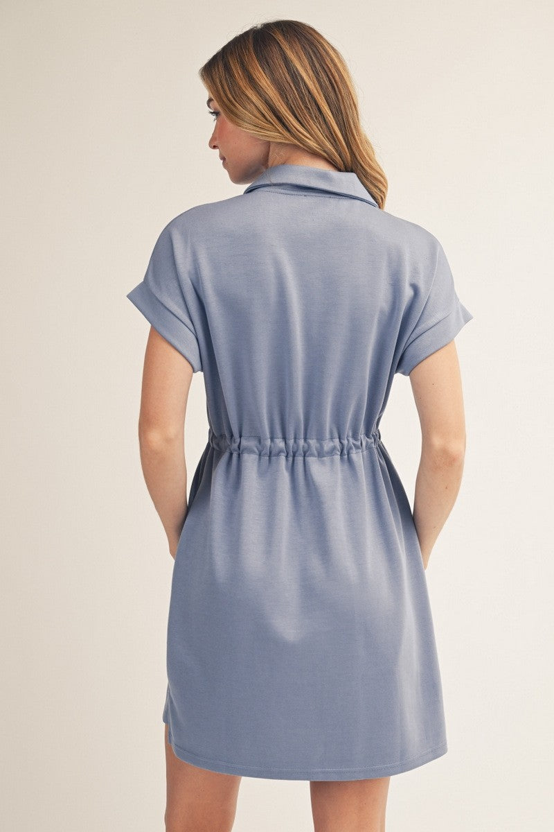 Woman wearing a light blue dress against a beige background
