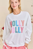 Person wearing a white sweatshirt with 'Holly Holly' text in colorful letters, standing against a neutral background.
