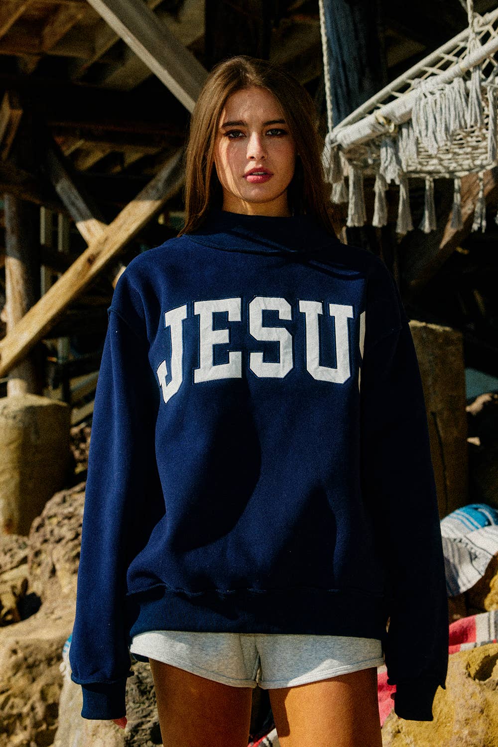 Person wearing a navy blue sweatshirt with &