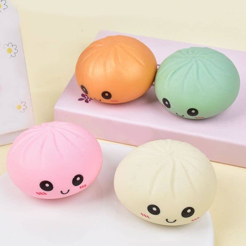 Four colorful squishy toys with face designs on a light background