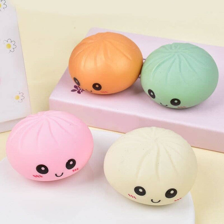 Four colorful squishy toys with face designs on a light background