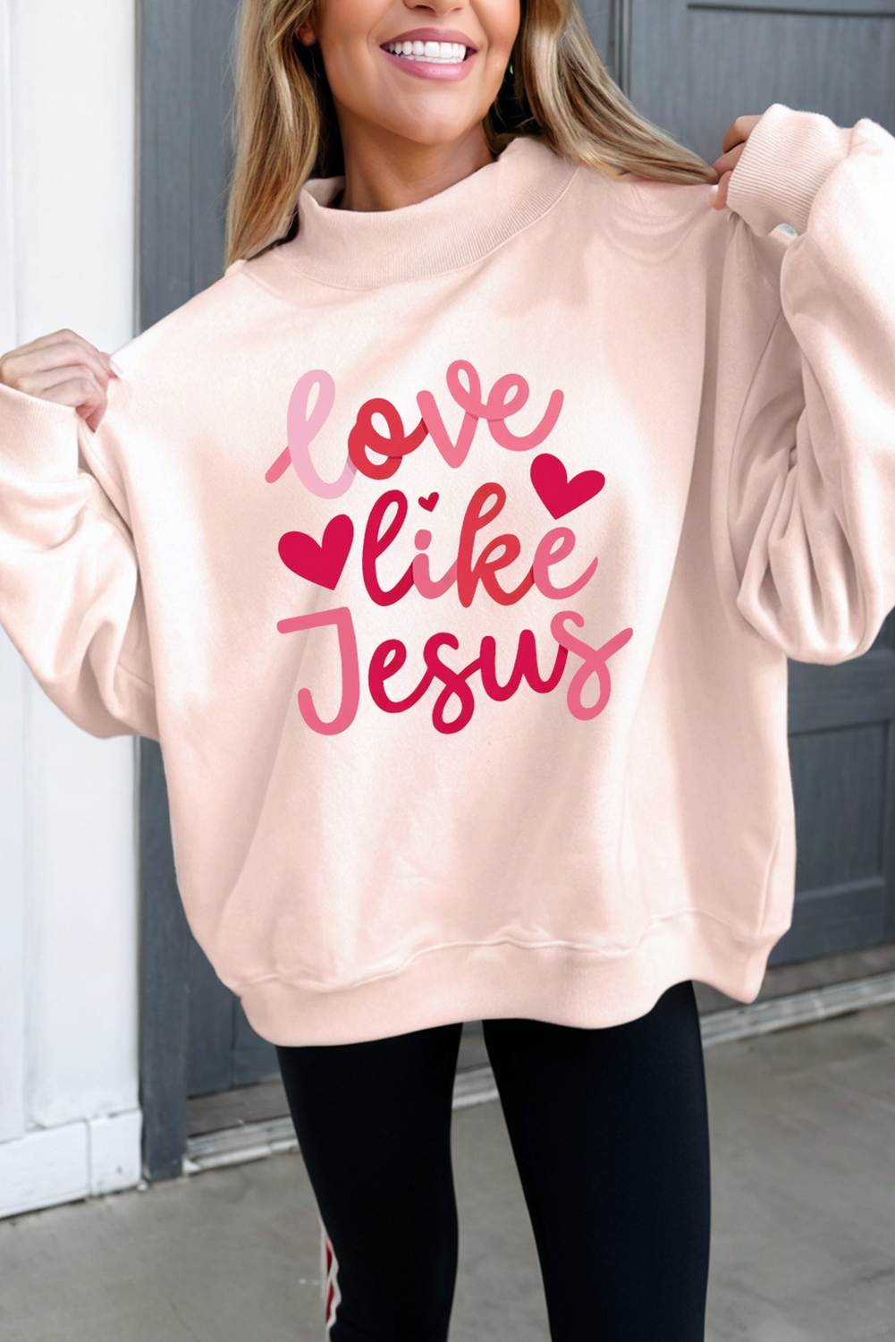 Person wearing a pink sweatshirt with &