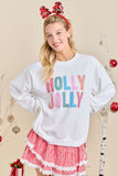 Woman wearing a 'Holly Jolly' sweater and red checkered skirt with Christmas decorations.