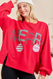 Person wearing a red sweatshirt with 'MERRI' and Christmas ball designs.