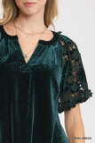 Teal green velvet dress with lace sleeves on a white background