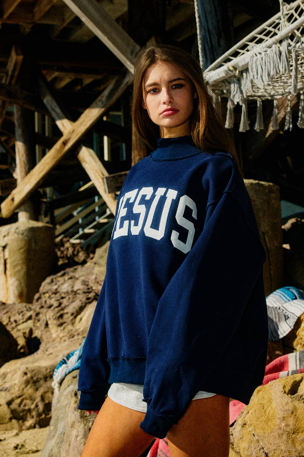 Person wearing a blue sweatshirt with &