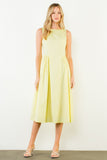 Woman wearing a light yellow dress against a white background