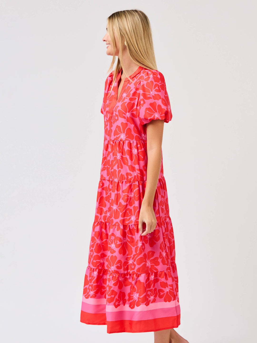 Woman wearing a red floral dress on a white background