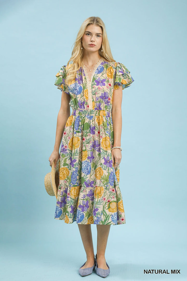 Woman wearing a floral dress against a light blue background
