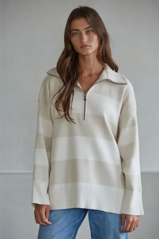 Woman wearing a striped sweater with a plain background