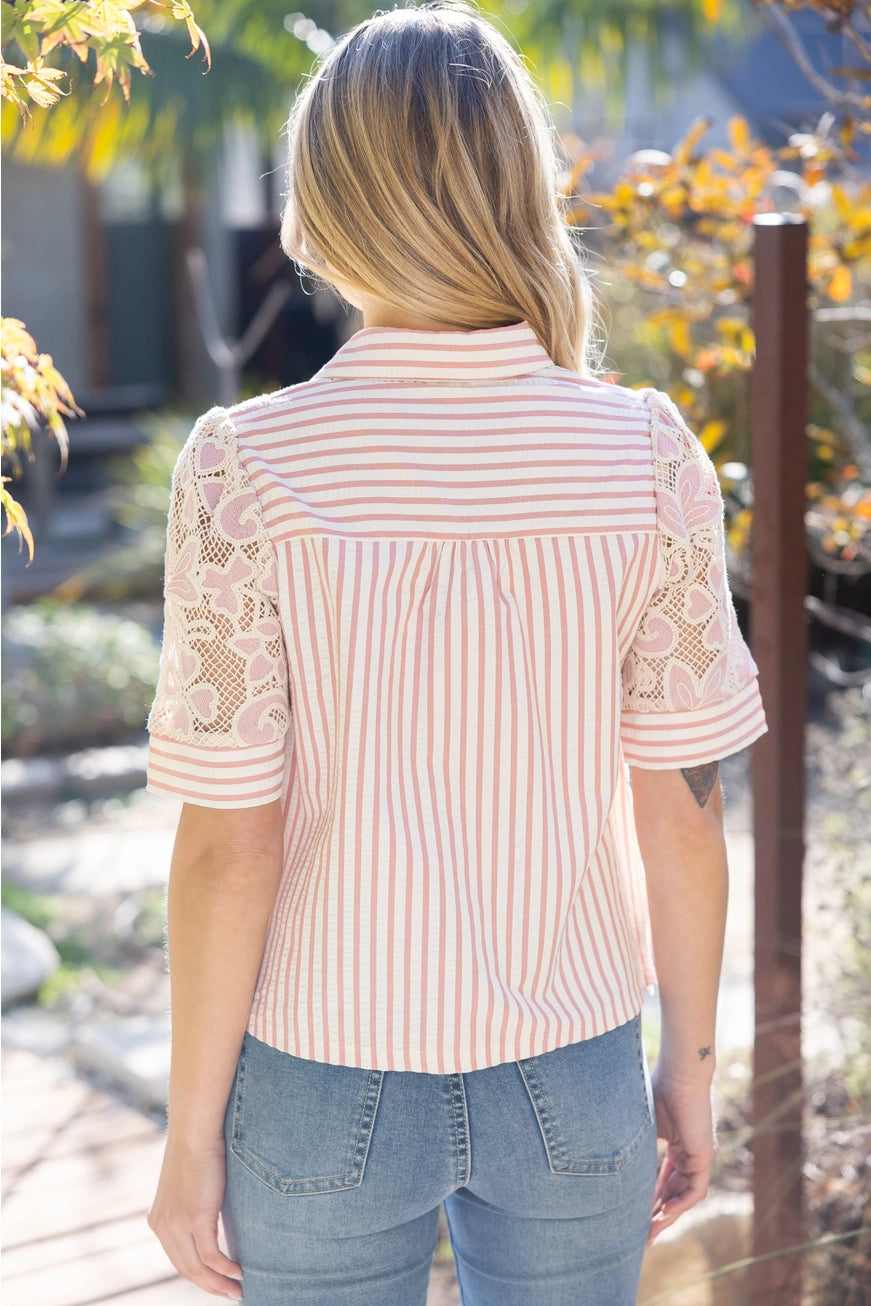 Woman wearing a lace blouse with floral patterns outdoors
