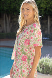Woman wearing a floral dress by a poolside
