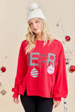 Woman wearing a red Christmas-themed sweatshirt with 'Merry' and ornaments on a beige background.
