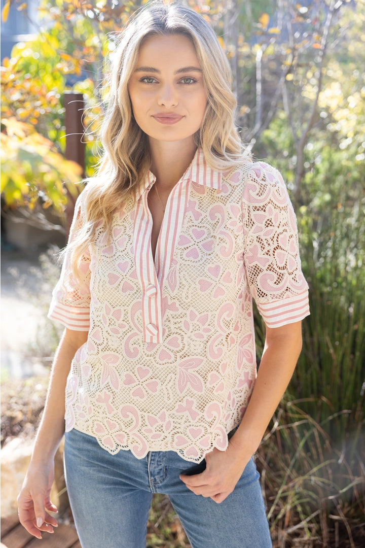 Woman wearing a lace blouse with floral patterns outdoors