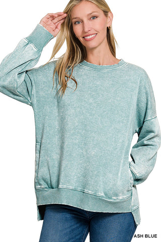 Woman wearing a light blue sweatshirt on a white background