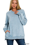Woman wearing a blue-grey sweater on a white background