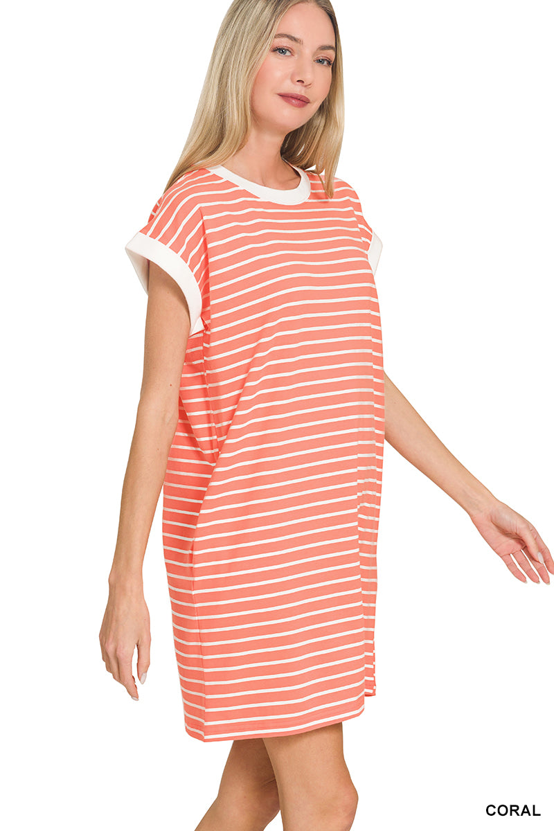 Woman wearing a coral and white striped dress on a white background