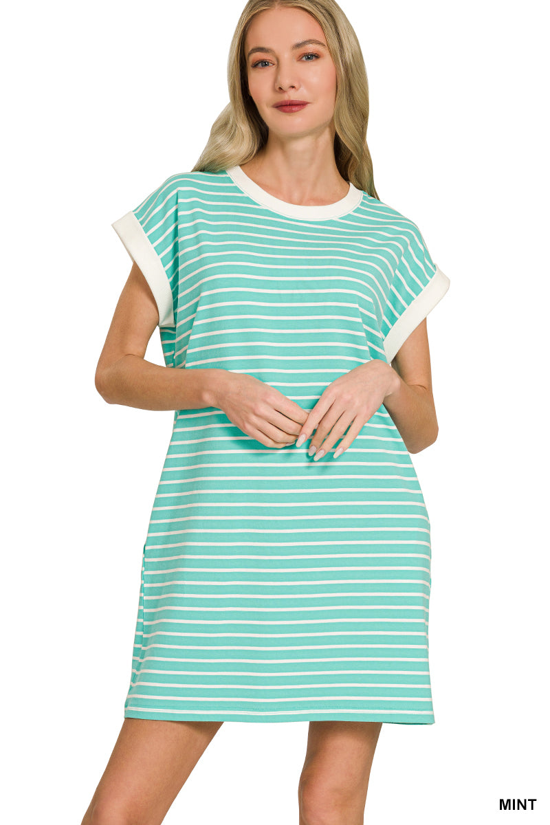 Woman wearing a mint green and white striped dress on a white background