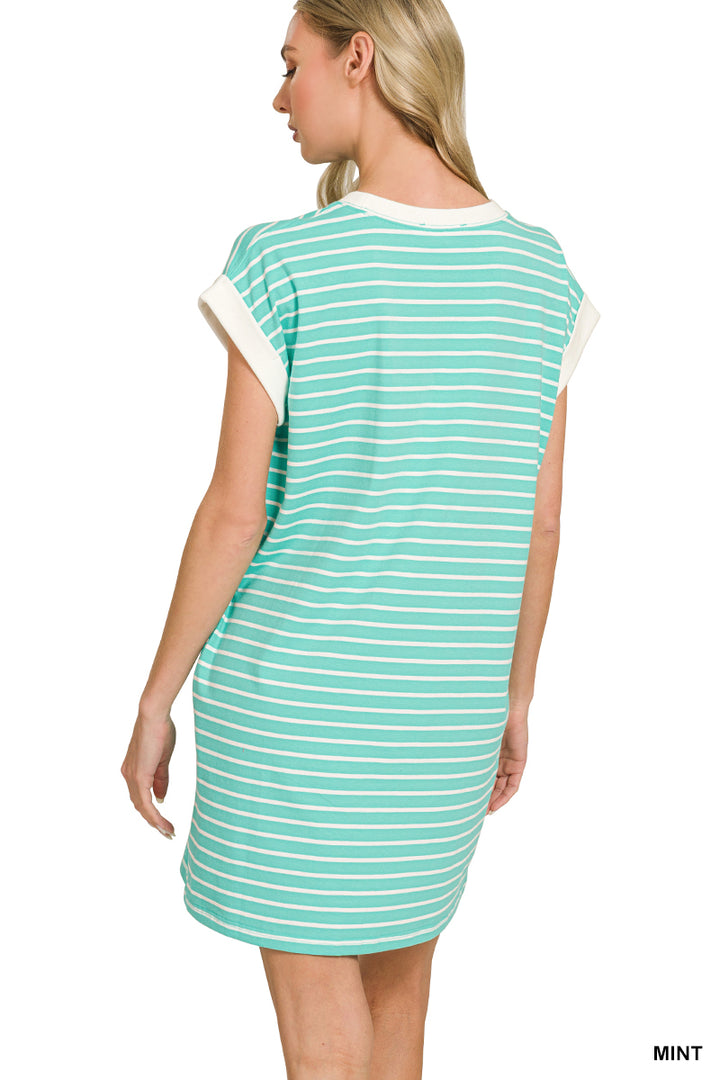 Woman wearing a mint and white striped dress on a white background