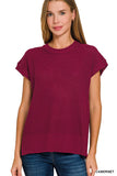 Woman wearing a maroon short-sleeve sweater on a white background