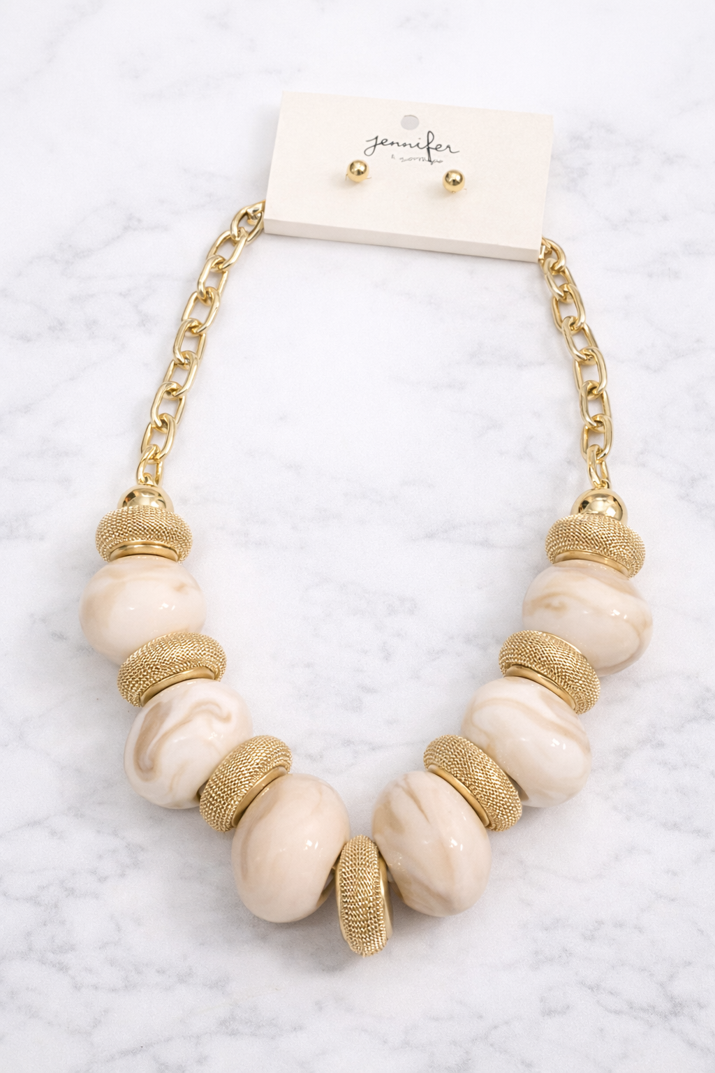 Necklace with gold and beige beads on a white background