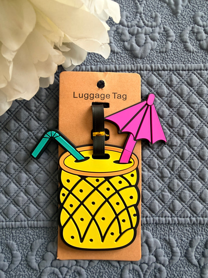 Luggage tag with pineapple design on a textured surface