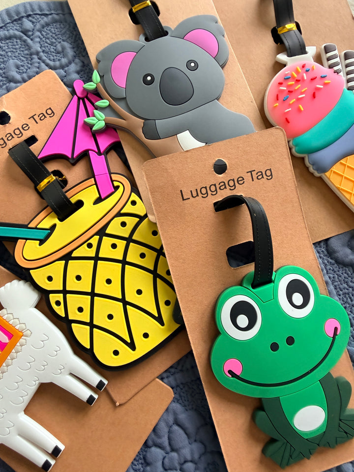 Collection of colorful luggage tags with various designs on a textured surface.