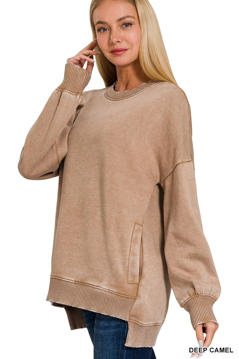 Woman wearing a beige sweater with a plain background